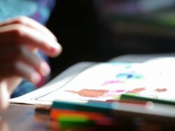 Little Girl Coloring a Picture Stock Footage