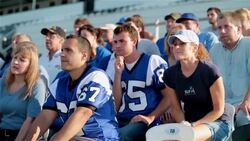 Anxious stadium crowd cheers at football game, jumps to feet Stock Footage
