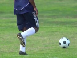 A man playing soccer on a grassy field. - Slow Motion - filmed at 240 fps Stock Footage