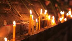 Buddhism lighted candles trail around ancient temple Stock Footage