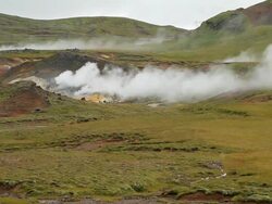 WS View of volcanic hotspots burning in grassy field / Porvaldseyri, Sudhurland, Iceland Stock Footage