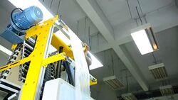 panning: young labor is on the top of blown film extruder Stock Footage