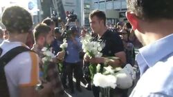Demonstrators give flowers to riot police on the fifth day of protests News Clip
