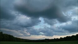 Cloud timelapse of a darkening sky over a field, 4K Stock Footage