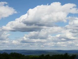puffy white clouds over foothills Stock Footage