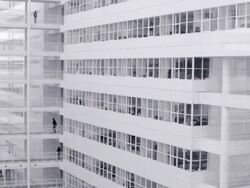 White office building with elevated walkway, crane-down camera movement Stock Footage