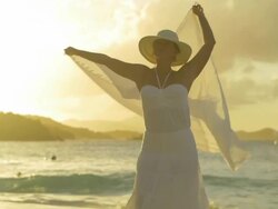 video of woman spinning in circles at a Caribbean beach Stock Footage