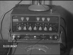 1952: FRANK HOLTON & CO.: ELKHORN: VS Frank Holton & Co. design engineer & chief tester & inspector Arvid Walters blowing into trumpet, playing jingle bells (SOT), testing w/ chromatic stroboscope machine. Wisconsin, WI, quality control Instructional Video