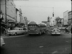 African Americas walk down a city sidewalk protesting the segregation of buses. News Clip