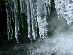 Icicles Hanging Over Pure Creek PAN Stock Footage