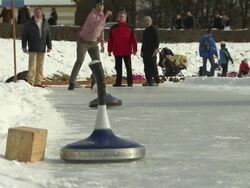 Nymphenburg, man shot curling stick over ice, viewers Stock Footage