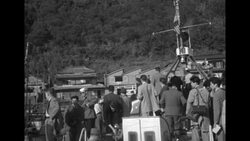 VS sailors and civilians on boat and examination of 1952 plane crash on Oshima Island, Japan News Clip