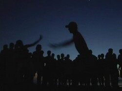 MS, Silhouettes of people performing capoeira on Jericoacoara beach at dusk, Brazil Stock Footage
