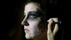 Artist hand painting woman's face for Halloween Stock Footage