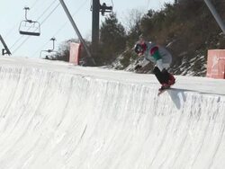 WS SLO MO TS View of Snowboarder jumping and turning with snowboard at ski slopes of Pyeongchang(The venue for the 2018 Winter Olympics ) / Pyeongchang, Gangwon do, South Korea  Stock Footage