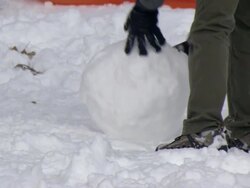  CU Family building snowman in Central Park / New York, New York, United States Stock Footage