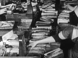 1952: CANADA: FISHING INDUSTRY: HA TD Production line w/ women in uniform boxing up, VS Packing Haddock fish filets as boxes move along conveyor belt in front of them, weighing boxes, TD MS Machine pushing boxes together.     Export, food, commercial Instructional Video