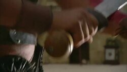 A Roman gladiator wipes blood from his sword onto his arm. Stock Footage