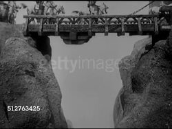 1924: GERMAN CINEMA: CLIPS From Fritz Lang's 'Nibelungen' silent film: Wooden gates being opened, horses over bridge, Paul Richter as Siegfried riding on white horse, walking in royal hallway, meeting w/ royality. MS Audience applauding. Instructional Video