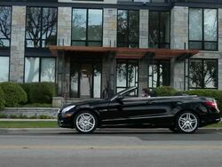 MS TU Young man talking on his cell phone outside in his modern convertible car in front of apartment building on sunny day in urban area / Minneapolis, Minnesota, United States Stock Footage