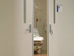 Nurse pushing a pregnant woman in a wheelchair in hospital Stock Footage