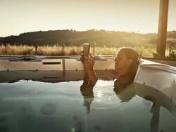 Woman in thermal bath with digital tablet Stock Footage