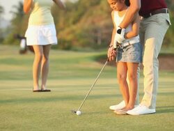 Girl playing golf with her father  Stock Footage