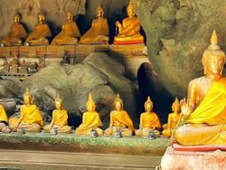 Sitting Buddhas at Khao Luang Cave Phetchaburi Stock Footage