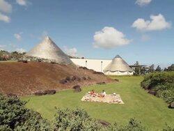 MS PAN Shot of two men sitting on blanket near cone like structures / kauai, hawaii, united states Stock Footage