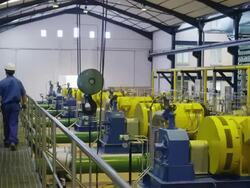 TS WS worker walking on gangway through compressor hall in water treatment plant, rear view, RED R3D 4K Stock Footage