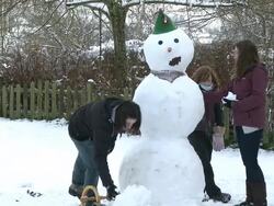 MS women building snowman / Saarburg, Rhineland-Palatinate, Germany Stock Footage