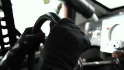 Stock-car driver's hands grip steering wheel Stock Footage