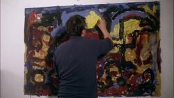 A man paints a mural on a wall. Stock Footage