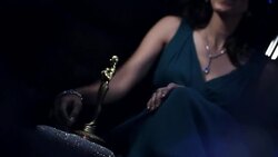Hollywood actress with awards trophy leans on her man in back of limousine at awards show Stock Footage