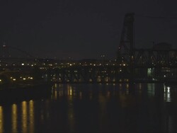 WS View of Three bridges of Freemont, Broadway and Steel bridge cross Willamette River in Portland, Oregon at night on rainy day / Portland, Oregon, United States  Stock Footage