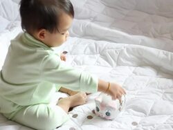 Boy inserting coins into piggy bank Stock Footage