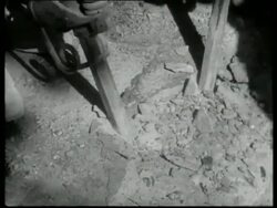 Manganese steel resists hard wear.  Tools used for heavy work are made of this alloy.  Stone breaking, UK 1939 Stock Footage