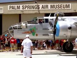 WS PAN ZO WWII B25 Mitchell Bomber plane slowly pulls out of air hangar with thousands of  memorial day  spectators watching from behind roped off area / Palm Springs, California , United states Stock Footage