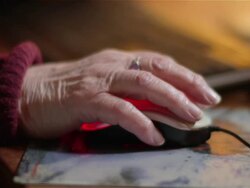 Elderly woman using a computer mouse Stock Footage