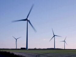 Timelapse zoom in to wind turbines on the skyline generating electricity. Renewable energy. Stock Footage