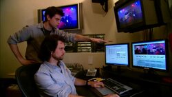MS Producer standing beside editor in studio and pointing at computer monitor/ New York, New York Stock Footage