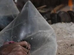 Man uses bellows to keep fire lit in blacksmiths Stock Footage