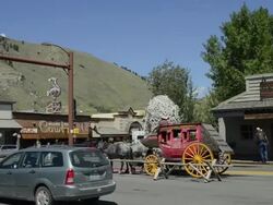 MS Beautiful stage coach rides moving on road in downtown center / Jackson Hole, Wyoming, United States Stock Footage