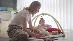 Army Mom Coloring Book for Adults and Playing With Her Baby. Stock Footage