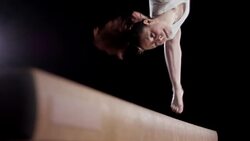 SLO MO Feet of female gymnast doing balance beam flip Stock Footage