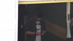 Jensen Ackles texting in a suicide squad t-shirt at Comic Con in San Diego in Comic-Con Celebrity Sightings Stock Footage