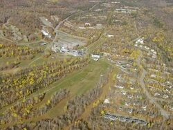 WS ARIEAL ZI View of wooded area with town /Maine, United States Stock Footage
