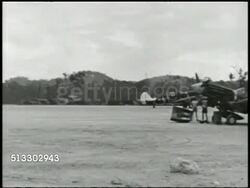 1943: PACIFIC THEATER: NEW GEORGIA: Angled WS Munda Point airfield, VS Curtiss P-40 'Warhawk' taking off, passing others parked FG. HA WS TRACKING Consolidated B-24 'Liberator' heavy bomber taking off.   WWII, World War II. Instructional Video