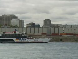 Pan Shot Excursion Ship In Saint Lawrence River With Molson Brewery Stock Footage