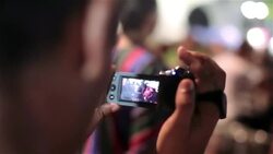 Man records Brazilian samba street performance with digital camcorder Stock Footage